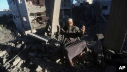 A Palestinian reacts after an Israeli strike on residential buildings in Rafah, Gaza Strip, on Dec. 15, 2023.