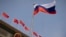 FILE - The Russian flag flutters at the Great Hall of the People in Beijing, May 24, 2023. The U.S. has added more Chinese companies to its Entity List for reportedly helping firms affiliated with the Russian military obtain U.S.-made goods that cannot legally be sold to them. 