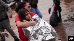 A firefighter carries a girl rescued from an area flooded by heavy rains in Porto Alegre, Rio Grande do Sul state, Brazil, May 4, 2024. 