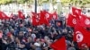 Supporters of Tunisia's Salvation Front opposition wave flags during a protest over the arrest of some of its leaders and other prominent critics of the president, in Tunis, March 5, 2023. 