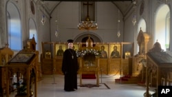 The Rev. Ioann Koval stands inside an old Orthodox church in Antalya, Turkey, July 16, 2023. Koval started serving in this church after the Russian Orthodox Church leadership decided to defrock him following his prayer for peace in Ukraine. 