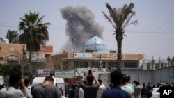 Smoke rises following an Israeli airstrike in Deir al Balah, Gaza Strip, April 23, 2024. 