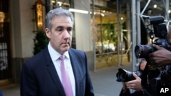 Michael Cohen leaves his apartment building on his way to Manhattan criminal court in New York, May 20, 2024. 