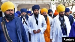 FILE - Amritpal Singh, a separatist Sikh leader, leaves the holy Sikh shrine of the Golden Temple along with his supporters, in Amritsar, India, March 3, 2023.