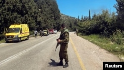 An Israeli soldier looks on at a scene after it was reported that people were injured, amid ongoing cross-border hostilities between Hezbollah and Israeli forces, near Arab al-Aramshe in northern Israel, April 17, 2024. 