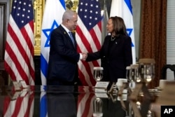 Vice President Kamala Harris shakes hands with Israeli Prime Minister Benjamin Netanyahu before a meeting at the Eisenhower Executive Office Building on the White House complex in Washington, July 25, 2024.