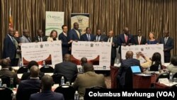 Checks totaling about $32 million are presented from African Risk Capacity to Zimbabwe for drought recovery, in Harare on July 4, 2024. 