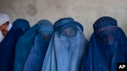 FILE - Afghan women wait to receive food rations distributed by a humanitarian aid group, in Kabul, Afghanistan, May 23, 2023. The Taliban were adamant on June 29, 2024, that they would not discuss women's rights in Afghanistan at a two-day U.N. meeting in Doha, Qatar.