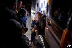 A boy is taken to an ambulance after being injured in the latest earthquake in Hatay, Turkey, Feb. 20, 2023.