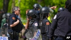 University of Chicago police stand between pro-Palestinian and pro-Israel protesters on the fifth day of a pro-Palestine encampment on campus, May 3, 2024, in Chicago. 
