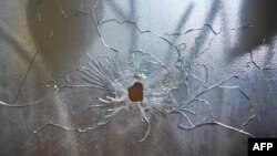 FILE - A bullet hole is seen in a glass door after an armed attack forced the closure of Fontaine Hospital in the Cité Soleil district of Port-au-Prince, Haiti, Nov. 18, 2023. 