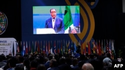 Delegates watch a screen that broadcasts a speech of President of the African Development Bank Akinwumi Adesina at the Kenyatta International Convention Centre in Nairobi on May 29, 2024.