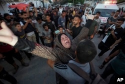Palestinian woman mourns relatives killed in the Israeli bombardment of the Gaza Strip outside a hospital in Deir al Balah, June 4, 2024.