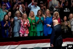 Republican presidential candidate former President Donald Trump greets supporters as he departs after speaking at a campaign event in Grand Rapids, Michigan, July 20, 2024.