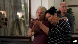Osnat Peri, right, whose husband, Haim, is in Hamas captivity, takes part in a Passover Seder commemoration with relatives of hostages held in the Gaza Strip, at the communal dining room at Kibbutz Nir Oz in Israel, April 11, 2024.