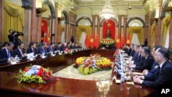 FILE - Vietnamese President Vo Van Thuong, sixth left, and Chinese President Xi Jinping, eighth right, meet at the Presidential Palace in Hanoi, Vietnam, on Dec. 13, 2023.