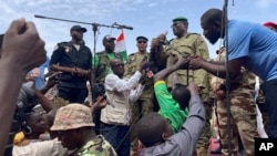 FILE - Mohamed Toumba, one of the soldiers who ousted Nigerian President Mohamed Bazoum, addresses supporters of Niger's ruling junta in Niamey on Aug. 6, 2023. The junta ordered its armed forces to go on highest alert on Aug. 25, 2023.