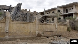 A damaged building is seen following an airstrike in Syria's eastern city of Deir el-Zour, March 26, 2024.
