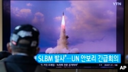 A man watches a TV screen showing footage of North Korea launching a missile from a submarine, during a news program at Seoul Railway Station in Seoul, South Korea, Oct. 20, 2021.