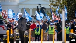 FILE - People protest for an extension and expansion of the Temporary Protected Status (TPS) program, Sept. 23, 2022, at Lafayette Park by the White House in Washington. 