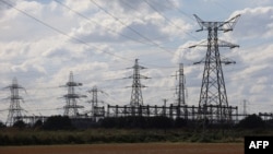 FILE - Electricity pylons are seen outside Keadby Power Station near Scunthorpe in northern England, Sept. 6, 2022.