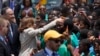 U.S. Vice President Kamala Harris greets school children during her arrival ceremony at Kotoka International Airport in Accra, Ghana, March 26, 2023. 