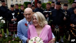 U.S. WWII veteran Harold Terens, 100, left, and Jeanne Swerlin, 96, arrive to celebrate their wedding at the town hall of Carentan-les-Marais in Normandy, France, June 8, 2024. 