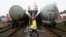 FILE - A worker walks past trains transporting oil tanks in Suining, Sichuan province, March 2, 2009. Talks reportedly have resumed after pandemic-related delays about a railway project in Myanmar to connect China's Yunnan province to the Bay of Bengal.