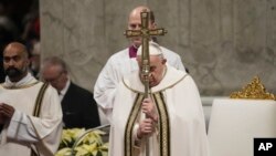 Pope Francis holds the pastoral staff as he presides over Christmas Eve Mass, at St. Peter's Basilica at the Vatican, Dec. 24, 2023.