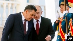 Kyrgyzstan's President Sadyr Japarov, left, and Russian President Vladimir Putin attend a welcome ceremony prior to their talks in Bishkek, Kyrgyzstan, Oct. 12, 2023. 