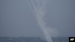 Rockets are fired towards Israel from the Gaza Strip, Oct. 9, 2023. Major airlines have suspended flights in and out of Israel after the nation declared war following a massive attack by Hamas.