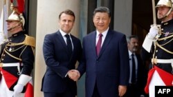 France's President Emmanuel Macron, left, greets Chinese President Xi Jinping at the Elysee Palace in Paris, May 6, 2024.