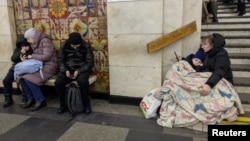 People take shelter in a metro station during an air raid in Kyiv, Ukraine, Jan. 23, 2024. The United Nations High Commissioner for Refugees said Wednesday that he's worried that the war in Ukraine has been forgotten amid other global crises.