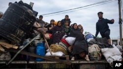 Palestinians arrive in the southern Gaza town of Rafah after fleeing an Israeli ground and air offensive in the nearby city of Khan Younis, Jan. 26, 2024. 