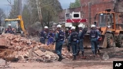 Russian emergency crews work near a Zagorsk optical plant after a blast in Sergiev Posad, northeast of Moscow, Aug. 10, 2023. The regional governor said the explosion damaged 38 apartment buildings. (Emergency Ministry Press Service via AP)