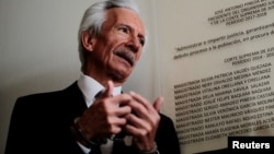 FILE - Journalist Jose Zamora, founder and president of El Periodico newspaper, talks with the media as he attends a court hearing in Guatemala City, Guatemala, Dec. 8, 2022. 