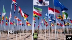 FILE- A member of the security forces stands guard outside a convention center hosting the IMF and World Bank annual meetings, in Marrakech, Morocco, Oct. 9, 2023.
