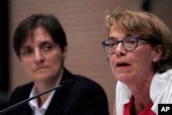 Helena Jeppesen Spuhler, right, delivers her speech with sister Nadia Coppa during a presentation of the new guidelines for the Synod of Bishops at the Vatican, June 20, 2023.