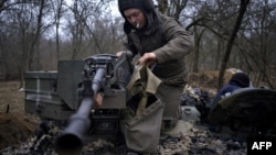 A Ukrainian serviceman of "Adam" tactical group prepares a T-64 tank to move to the positions on the front line near Bakhmut, on March 19, 2023, amid the Russian invasion of Ukraine. 