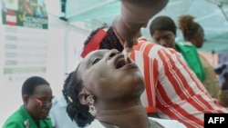 FILE - A nurse administers a dose of the cholera vaccine at the Kuwadzana Polyclinic in Harare, Zimbabwe, Jan. 29, 2024. On Wednesday, the World Health Organization called for action to combat a worldwide spike in cholera cases amid a global vaccine shortage. 