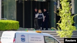 Police deploy at the scene of a mass shooting at Old National Bank in downtown Louisville, Ky., April 10, 2023.