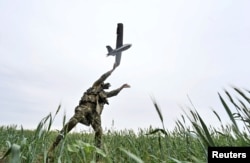A Ukrainian serviceman launches a reconnaissance drone for flying over positions of Russian troops, in Zaporizhzhia region, May 26, 2024.