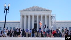 People protest outside the Supreme Court, July 1, 2024, in Washington. 