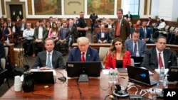 FILE - Former President Donald Trump sits in the courtroom with his legal team before the continuation of his civil business fraud trial at New York State Supreme Court, Oct. 3, 2023, in New York. Trump's bid to postpone the trial was rejected Oct. 6.