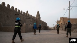 FILE - Police officers of the United Nations Stabilization Mission in Mali (MINUSMA) secure access to the Great Mosque in Timbuktu, on Dec. 9, 2021.