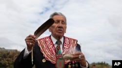 D-Day veteran and Penobscot elder from Maine, Charles Norman Shay, burns sage in prayer at Omaha Beach in Normandy, France, on June 5, 2020.