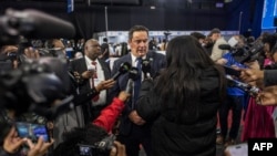 Leader of the Democratic Alliance (DA), South African main opposition party, John Steenhuisen, center, speaks with the media at the Independent Electoral Commission National Results Center in Midrand, May 31, 2024.