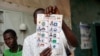 FILE - A poll worker holds a ballot during ballot counting at a polling station during the presidential election in N'Djamena, Chad, May 6, 2024. 