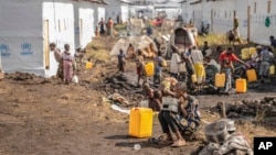 People displaced by fighting between Congolese forces and M23 rebels gather in a camp on the outskirts of Goma, Democratic Republic of Congo, March 13, 2024. The WHO warns that hunger, poverty, malnutrition, and disease have reached alarming levels in the DRC.