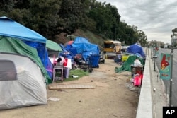 FILE - Tenda berjajar di jalan layang di North Hill Street di atas Cesar Chavez Avenue dekat A.S. 101 di Los Angeles, November. 15, 2023. (AP/Christopher Weber)